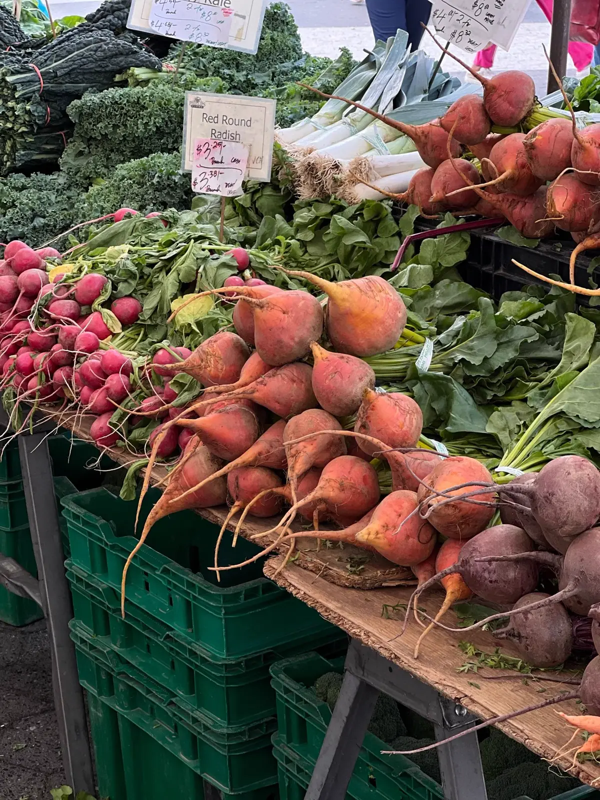 Golden and red beets with their leafy tops at a market